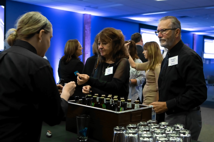 Empower Social attendees order drinks at the bar