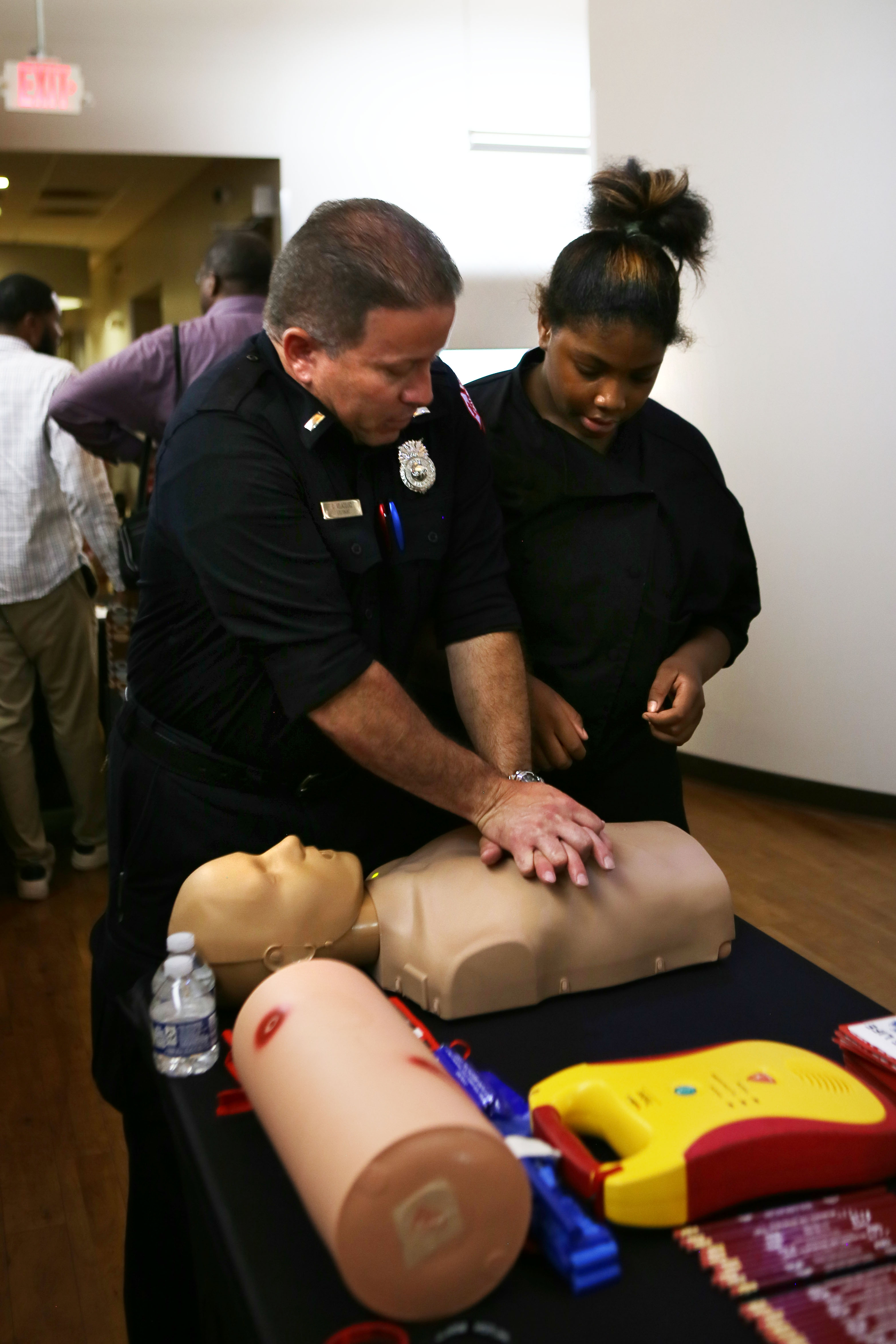 Lieutenant Carlos Velazquez-Sanchez from the Milwaukee Fire Department demonstrates CPR on a dummy