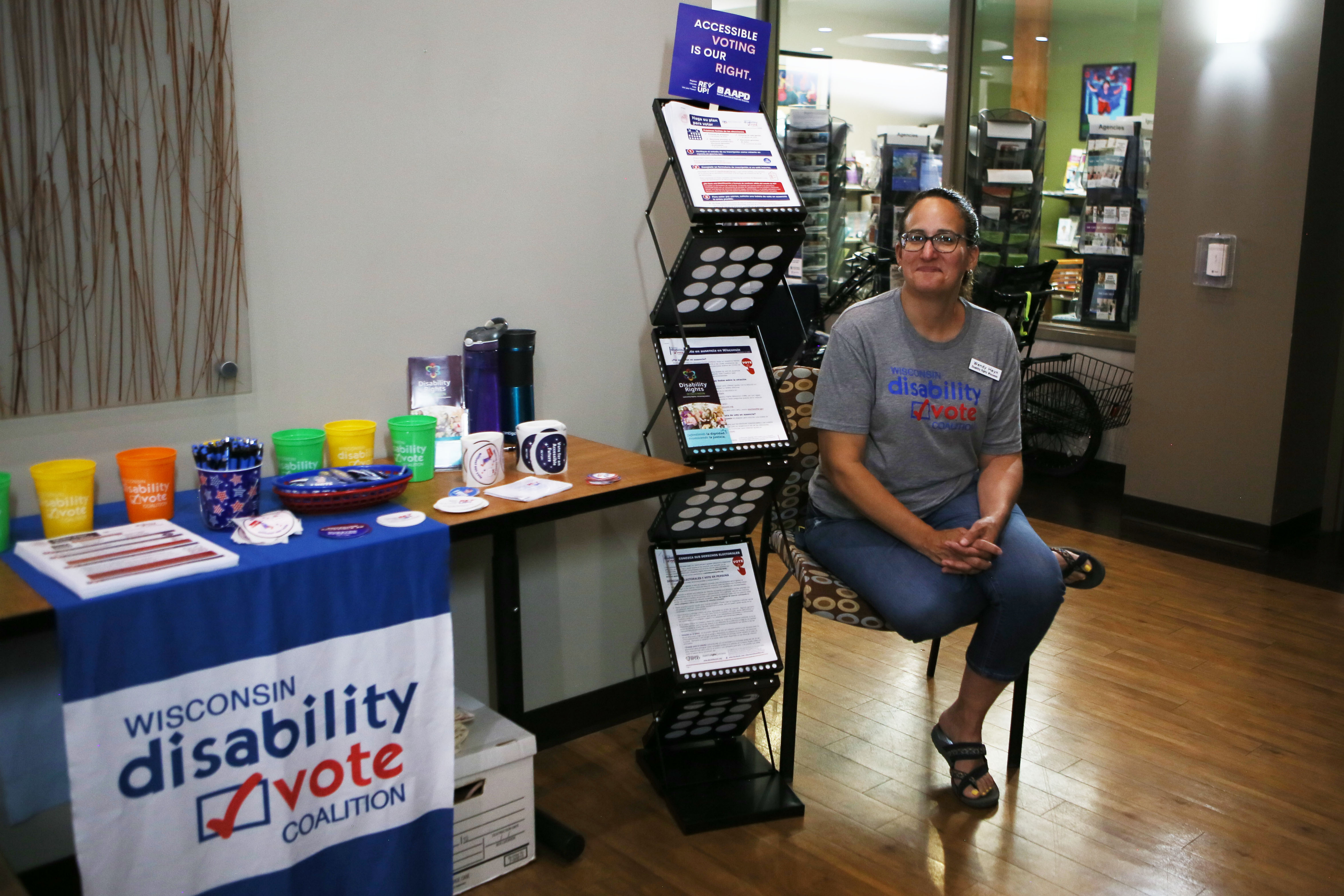 Wendy Heyn with Disability Vote Coalition sits with literature about voting rights at the resource fair