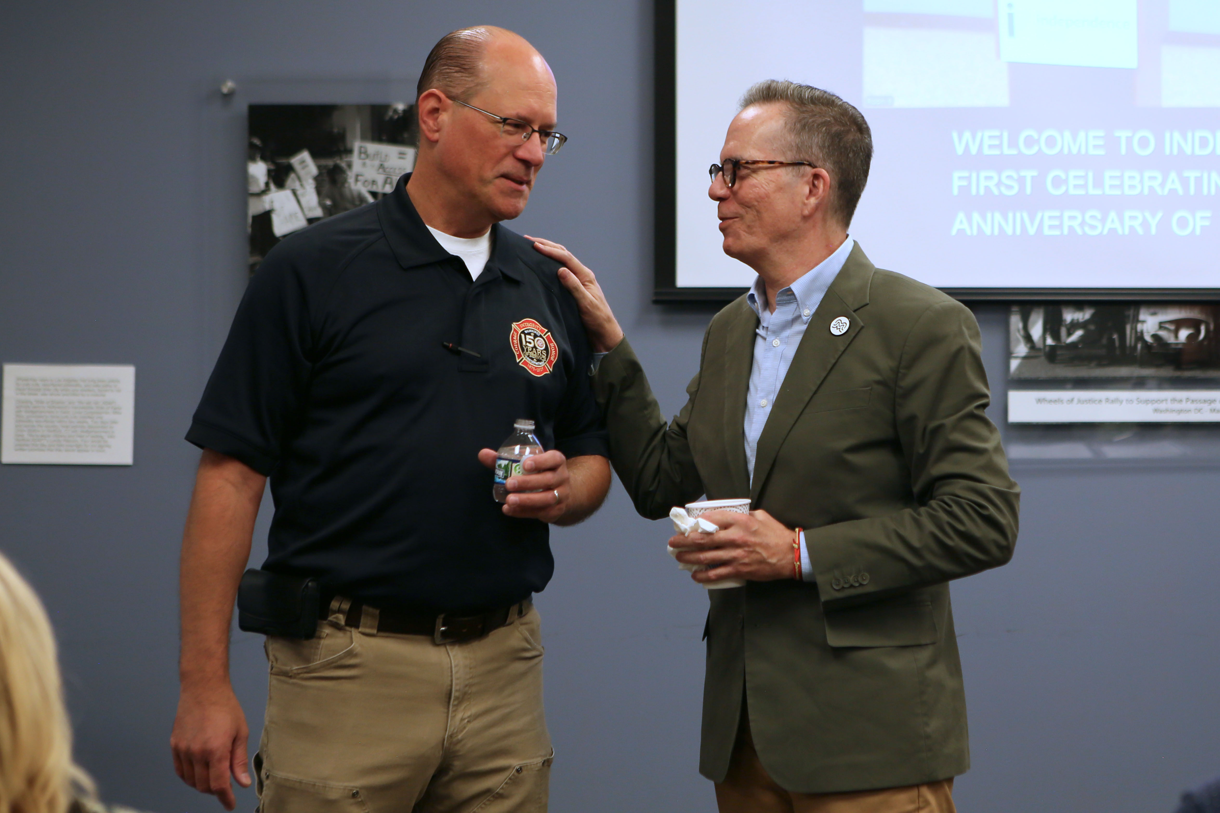 Tony Snell Rodriguez, Director of Community Engagement and Inclusion at Visit Milwaukee and Chair of the Equal Rights Commission, and Fire Chief Aaron Lipski have a conversation before the program