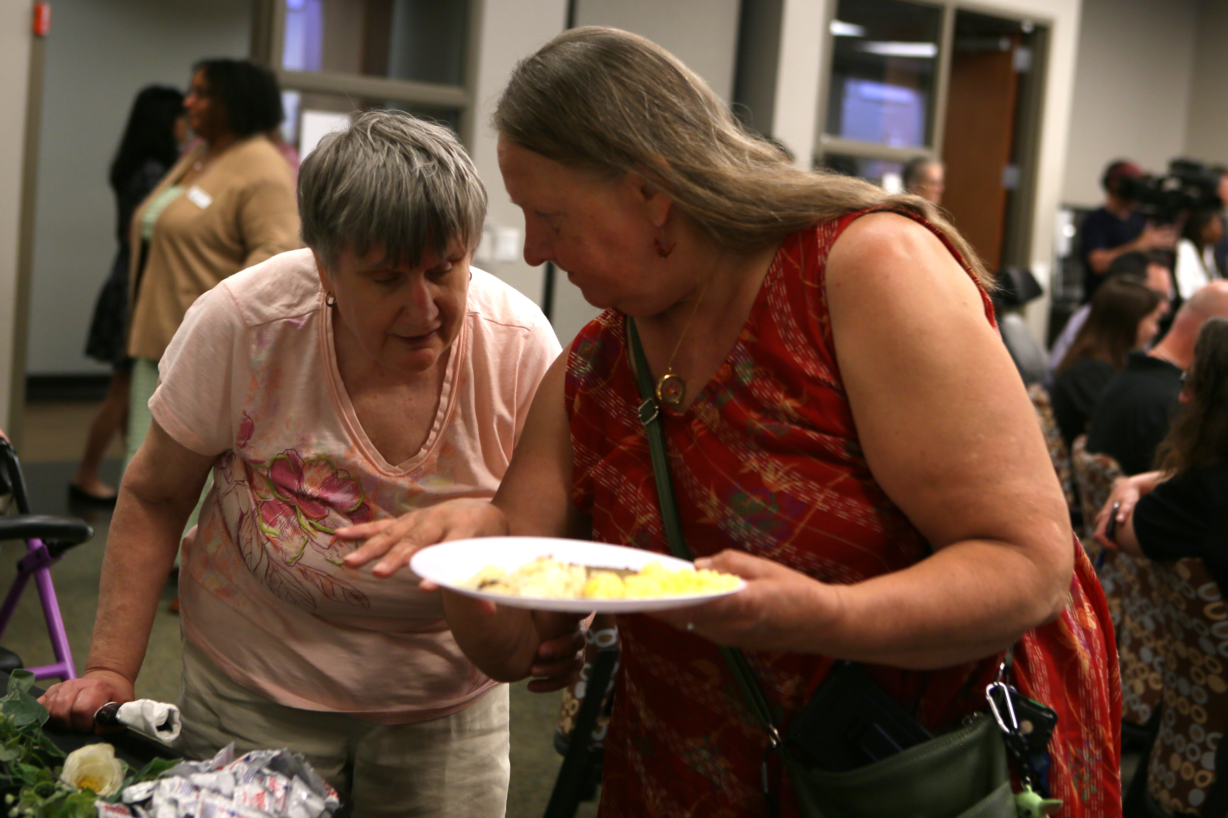 attendees talk while in line at the breakfast buffet