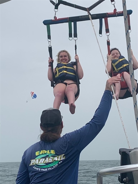 Emily and a friend parasailing