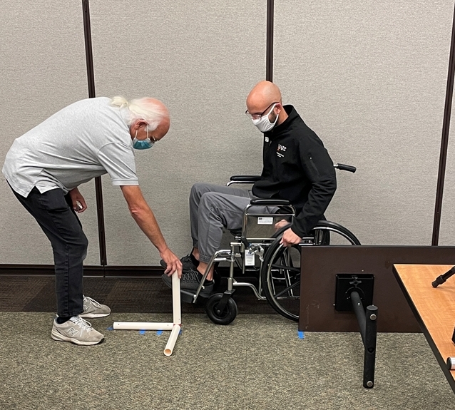 A student participates in an exercise using a wheelchair