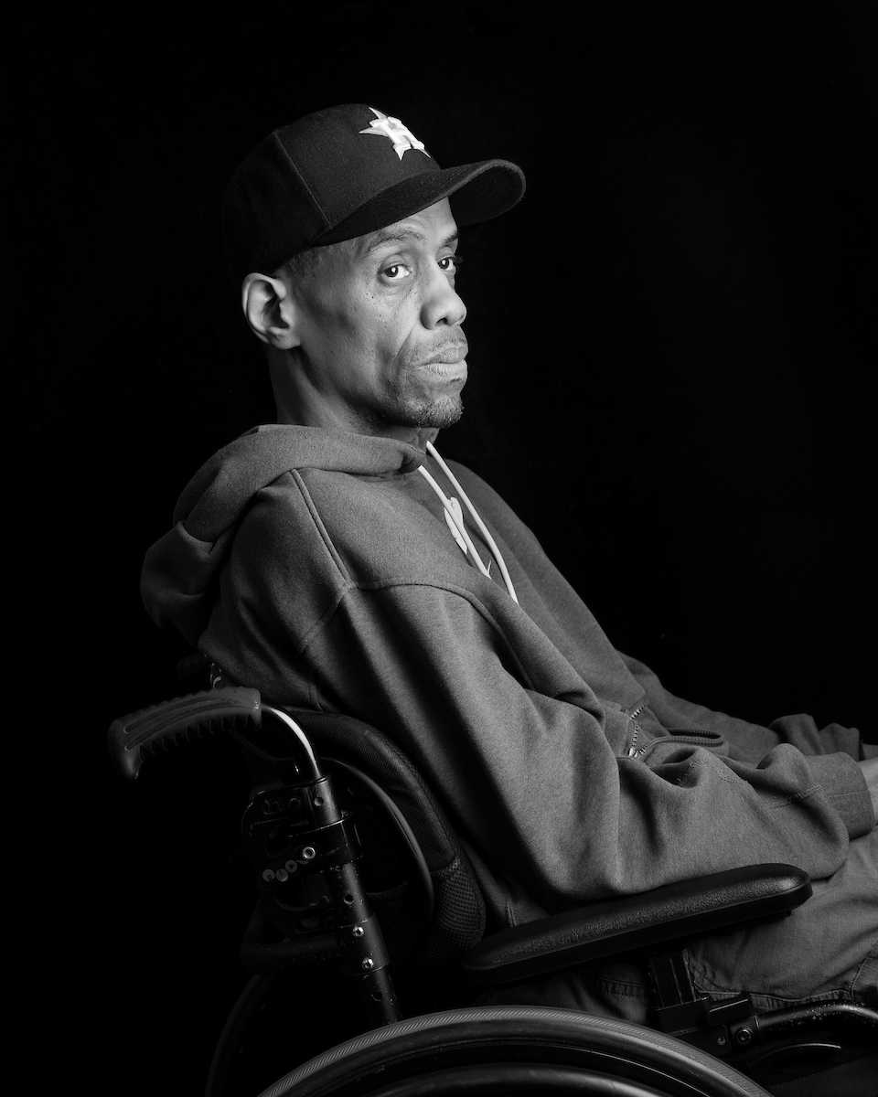 Black and white portrait of Harvey Ross, seated in a wheelchair