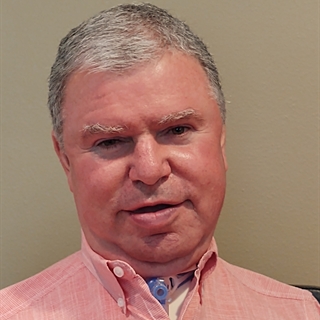 Scott Luber is pictured wearing a pink shirt.