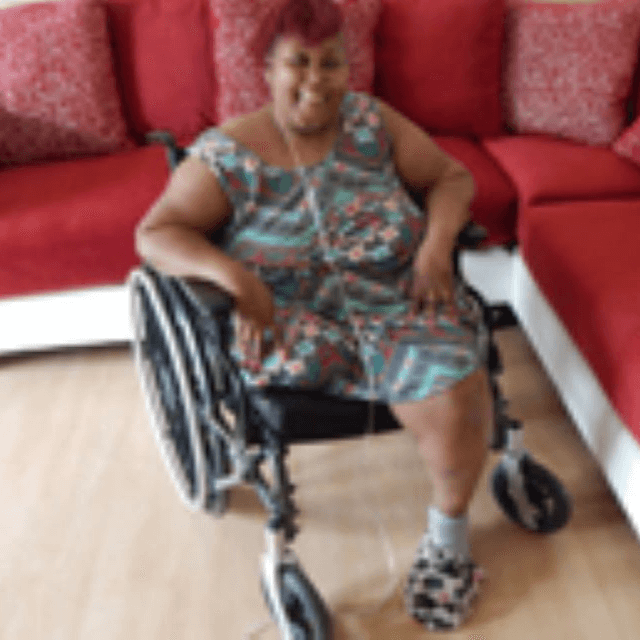 Woman Using Oxygen and A Wheelchair Sitting In Her Living Room