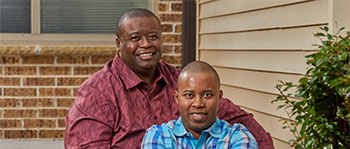 Two men sitting on the stairs together.