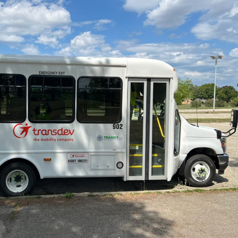 A white TransDev van with an accessible entrance for mobility devices