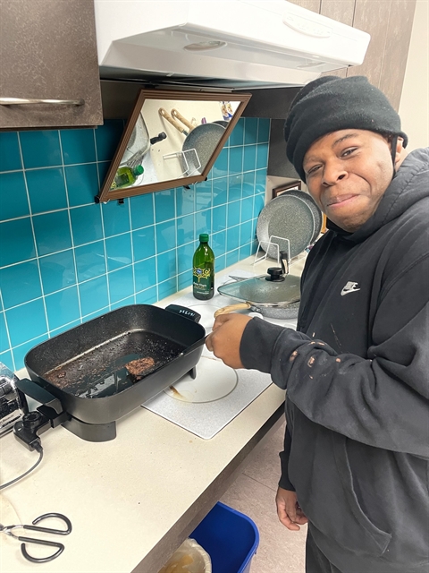 Troy Smith cooks a burger on the stove