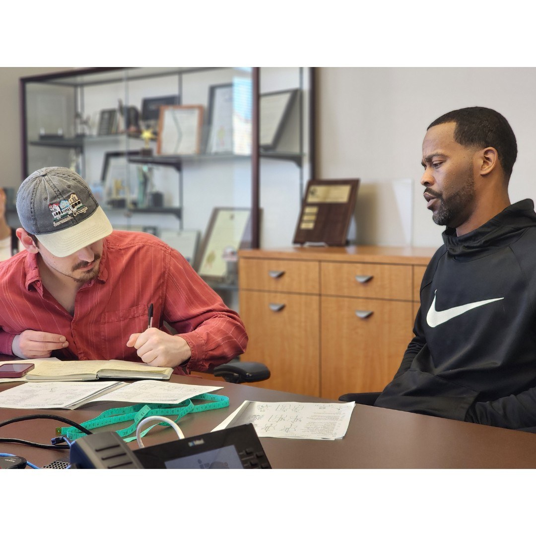 Designer Zachary Scharrer takes notes w hile interviewing Mike Wolfe