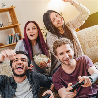 Teens playing video games with snacks