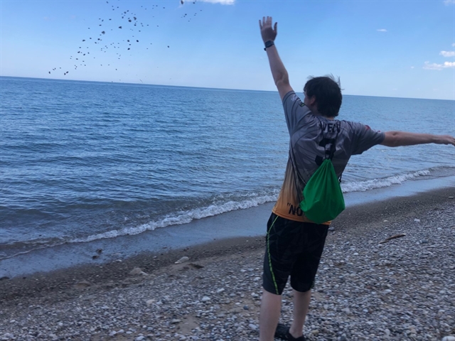 Cam enjoying Lions Den beach throwing rocks