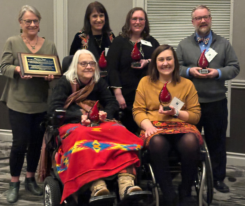 Awardees named Relentless Badgers pose with their awards
